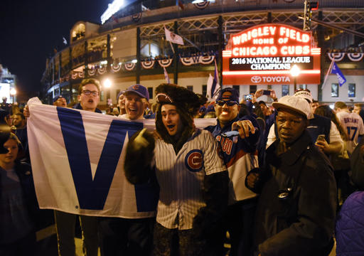 Chicago Cubs fans celebrate outside Wrigley Field after the Cubs defeated the Los Angeles Dodgers 5-0 in Game 6 of baseballs National League Championship Series, Saturday, Oct. 22, 2016, in Chicago. The Cubs advanced to the World Series. (AP Photo/Matt Marton)