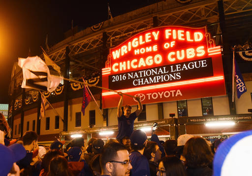 Chicago Cubs fans celebrate outside Wrigley Field after the Cubs defeated the Los Angeles Dodgers 5-0 in Game 6 of baseballs National League Championship Series, Saturday, Oct. 22, 2016, in Chicago. The Cubs advanced to the World Series. (AP Photo/Matt Marton)