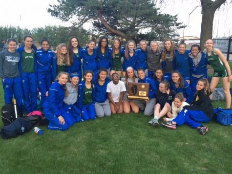 New Trier girls varsity track celebrate a sectional title win by holding up the plaque     | New Trier Athletics Twitter