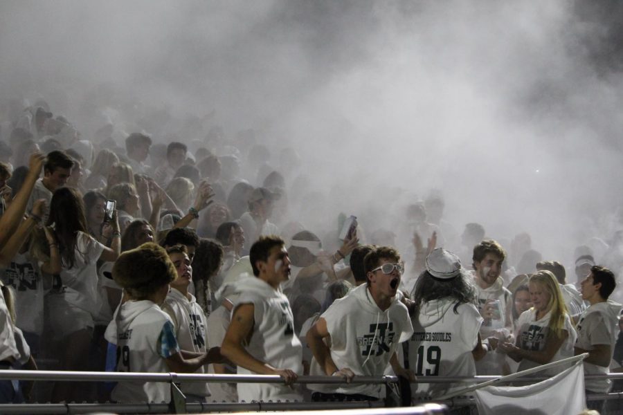Enthusiastic fans cheer on the home team while decked out in all-white at the Northfield stadium 