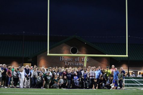 Jane McNamara and staff pose in front of the new building next to Robert Naughton Field 