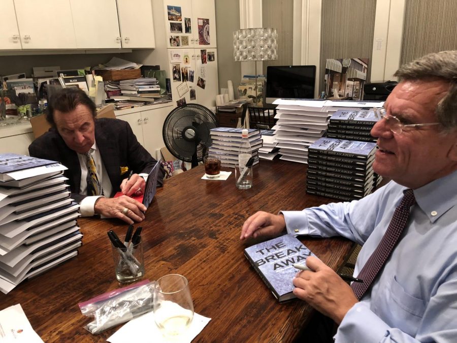 Tony Esposito (left) and Rocky Wirtz (right) sign copies of “The Breakaway” at local Maze Home store  