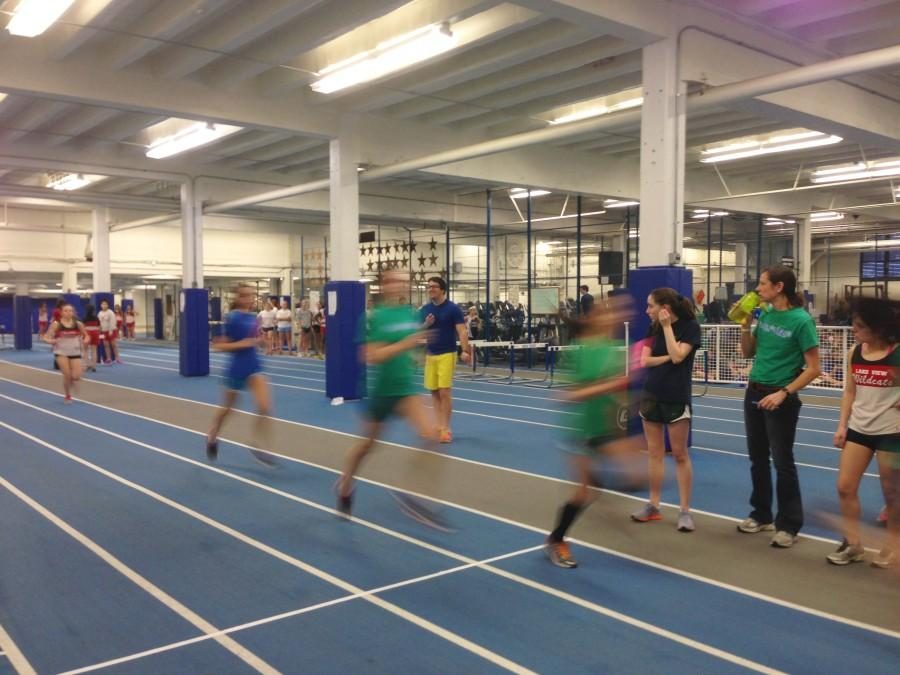 Track and field runs laps for a meet in field house. NT teams are also competing for space
