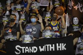 Hong Kong residents hold up signs in support of Daryl Morey at a rally on Oct. 15, 2019 