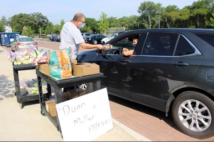 Science teacher John Miller distributes Physics materials on Trevian Way 