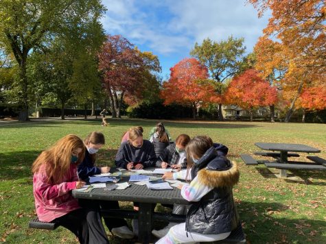 The group Students Demand Action Wilmette gathers for a post-card writing event