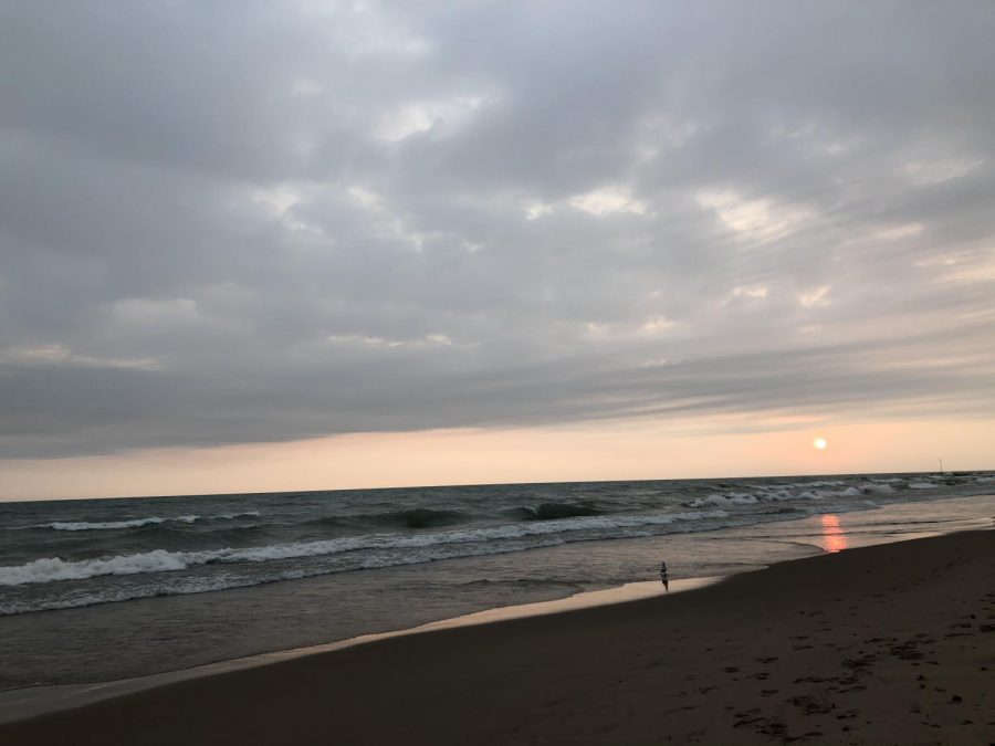 The rising sun peaking through a thin haze of clouds the morning of Oct. 11