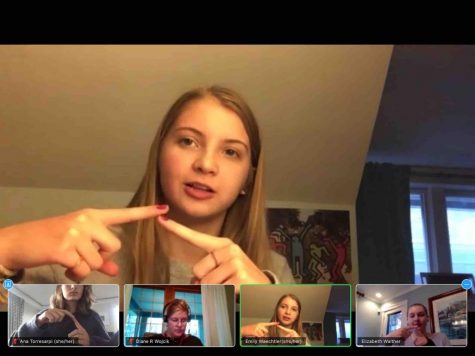 Emily Waechtler demonstrates the sign for where during a recent meeting of the Sign Language Club