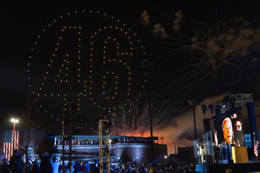 Drones spelling out “46” light up the sky as President-elect Biden appears on a video monitor after giving his acceptance speech