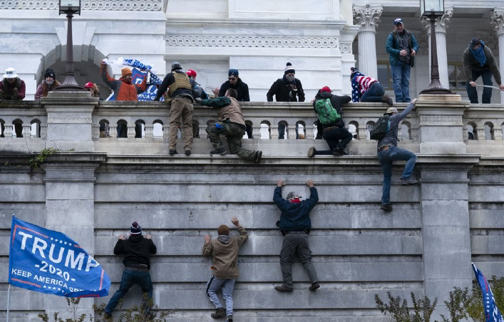 Trump supporters and right wing rioters climb the West wall of the Capitol, attempting to nullify President-elect Bidens victory in the 2020 election