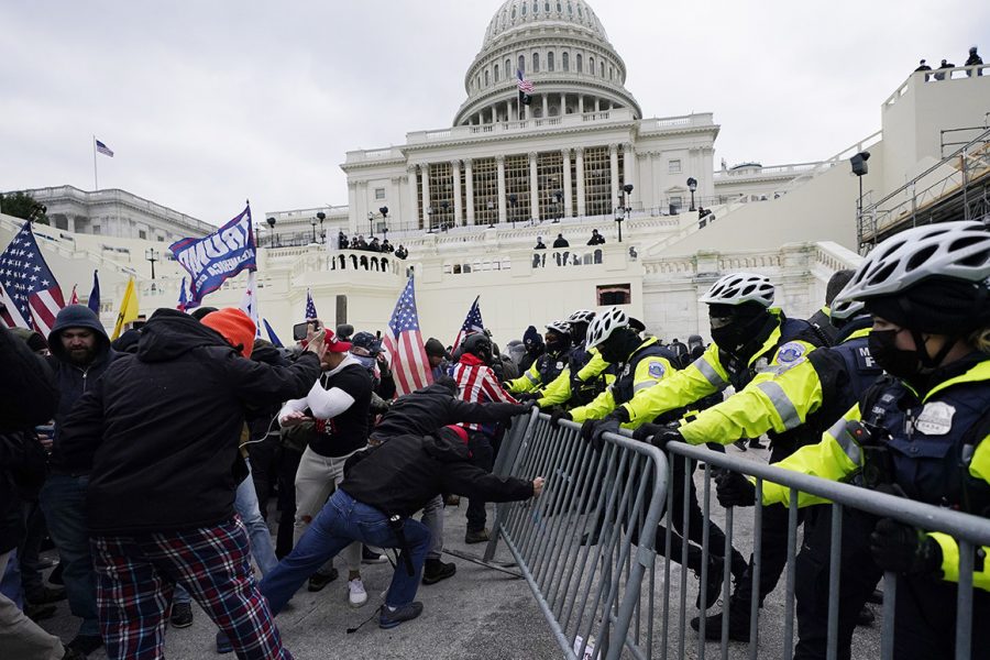 Trump supporters try to break through a police barrier at the Capitol on Jan. 6. On Jan. 7 many teachers held discussions in class about the events