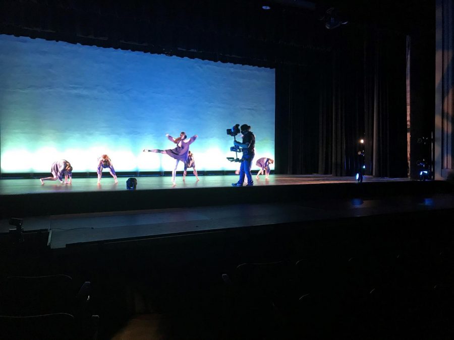 On stage, cameraman Guy Rhodes navigates through a dance choreographed by senior Madeline Brown offering viewers an up-close perspective unique to that of a typical dance performance.