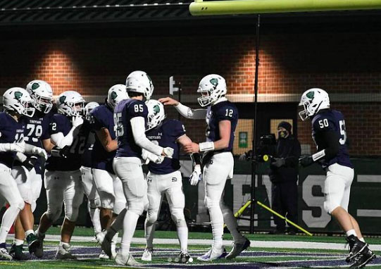  New Trier celebrates in the end zone after a touchdown in a 28-7 win against Glenbrook South 