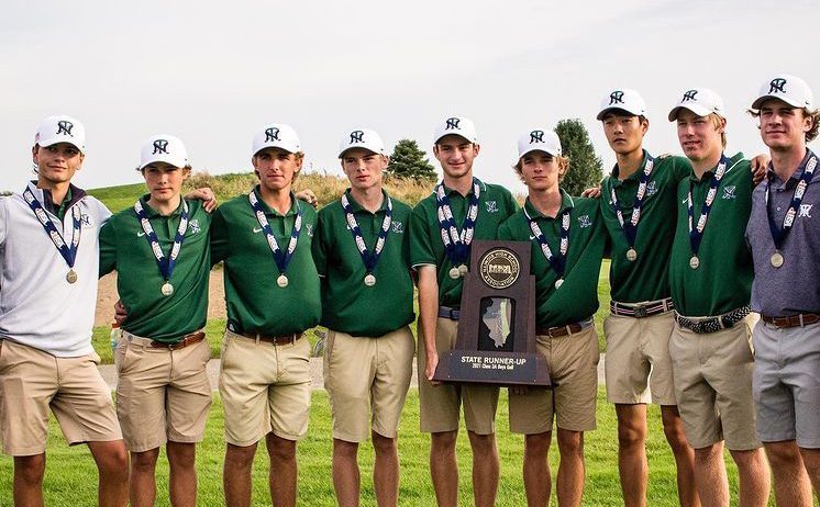 New Trier boys golf team holds state runner-up trophy on October 9 at the IHSA State Finals
