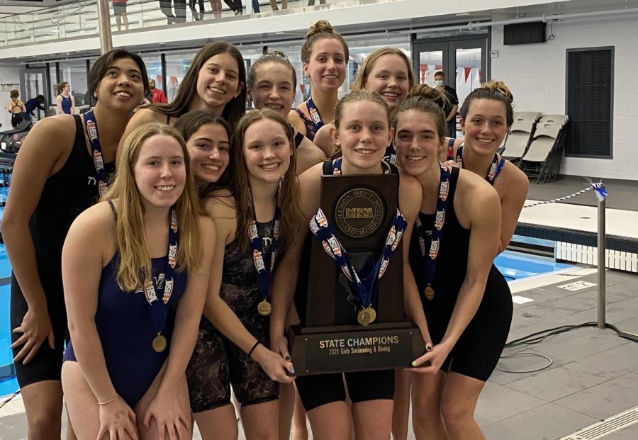 The team poses with their championship trophy after finishing first at the State finals at FMC Natatorium in Westmont, IL on Nov. 13