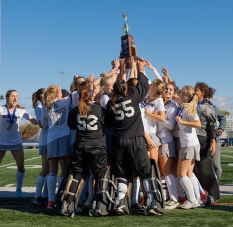 New Triers field hockey team celebrating their championship trophy after defeating Oak Park River Forest 4-0 on Oct. 30.