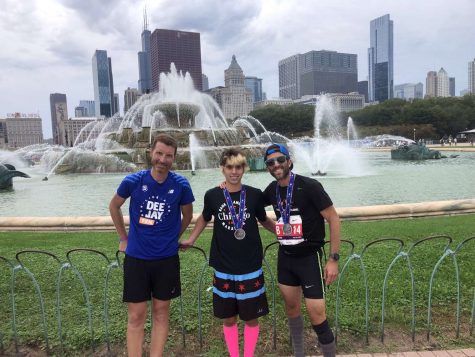 Tamar Frydman (center), James Frydman (right), and Roberto Mazza (left) commemorate their achievements at the Chicago Marathon. 