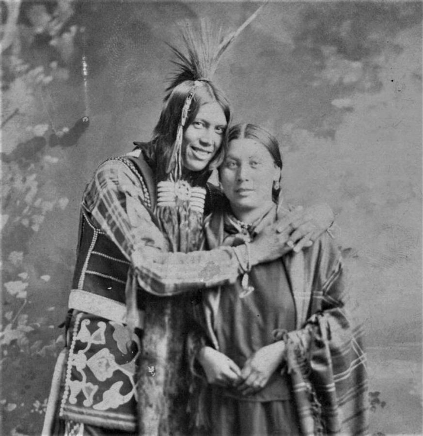 Portrait of a Native American man smiling and hugging a woman 