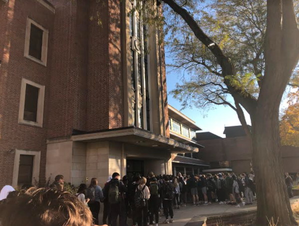 Students waiting in line to get into the building at New Triers south entrance