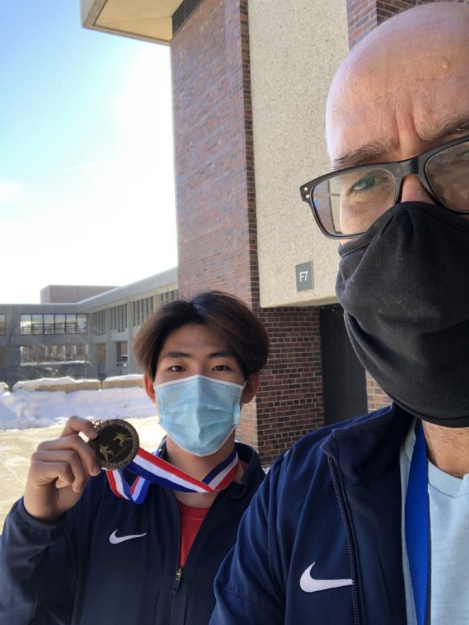 On Feb. 5, bronze medalist Xingyuan Huang (left) commemorated his conference success with a selfie with coach Colby Vargas (right)