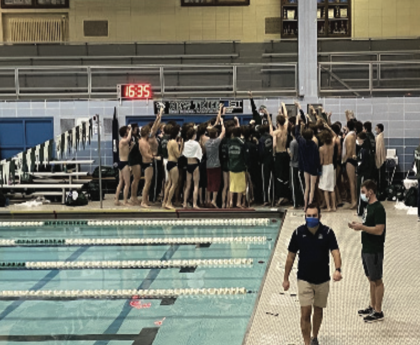 Swim team does a pre-game chant before beating ETHS at a home meet