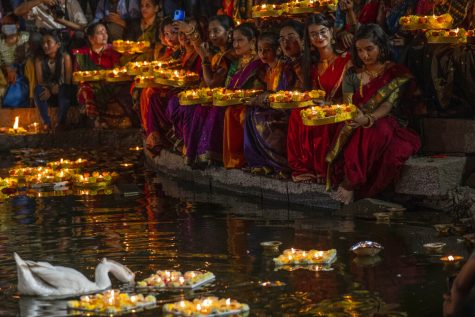Hindu women hold oil lamps at the Banganga pond as they celebrate Dev Diwali festival in Mumbai, India, Monday, Nov. 7, 2022. (AP Photo/Rafiq Maqbool)