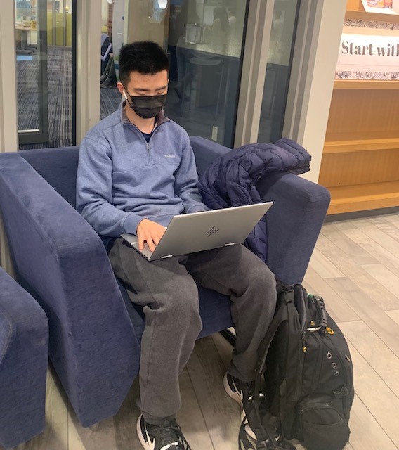 Senior+Zijun+Deng+finishes+homework+on+his+laptop.+Students+require+WiFi+to+use+different+devices%2C+including+iPads%2C+laptops%2C+and+phones.