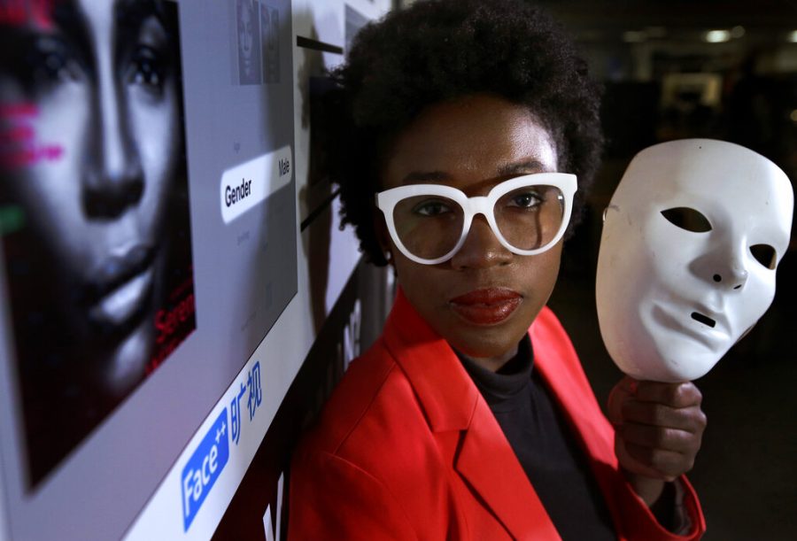 MIT facial recognition researcher Joy Buolamwini stands for a portrait. AI algorithms were unable to detect her face until she put on a white mask.