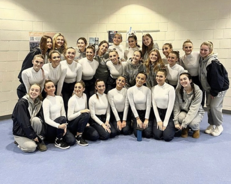 New Trier Dance Team poses elatedly after qualifying for state at the IHSA state qualifier competition following their close qualification last year