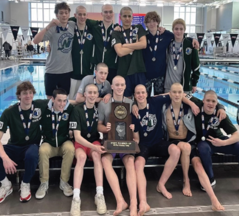 New Trier Boys Swim and Dive takes picture with and celebrates hard-earned 2nd place trophy at the IHSA state competition on Feb. 25 
