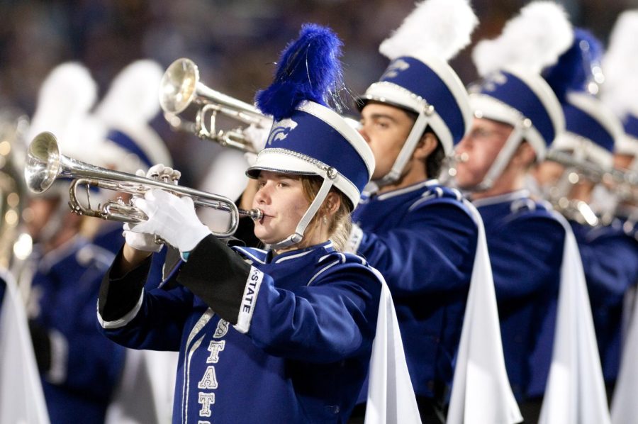The Kansas State University Marching Band is featured playing their musical instruments loud and proud for those in the crowd
