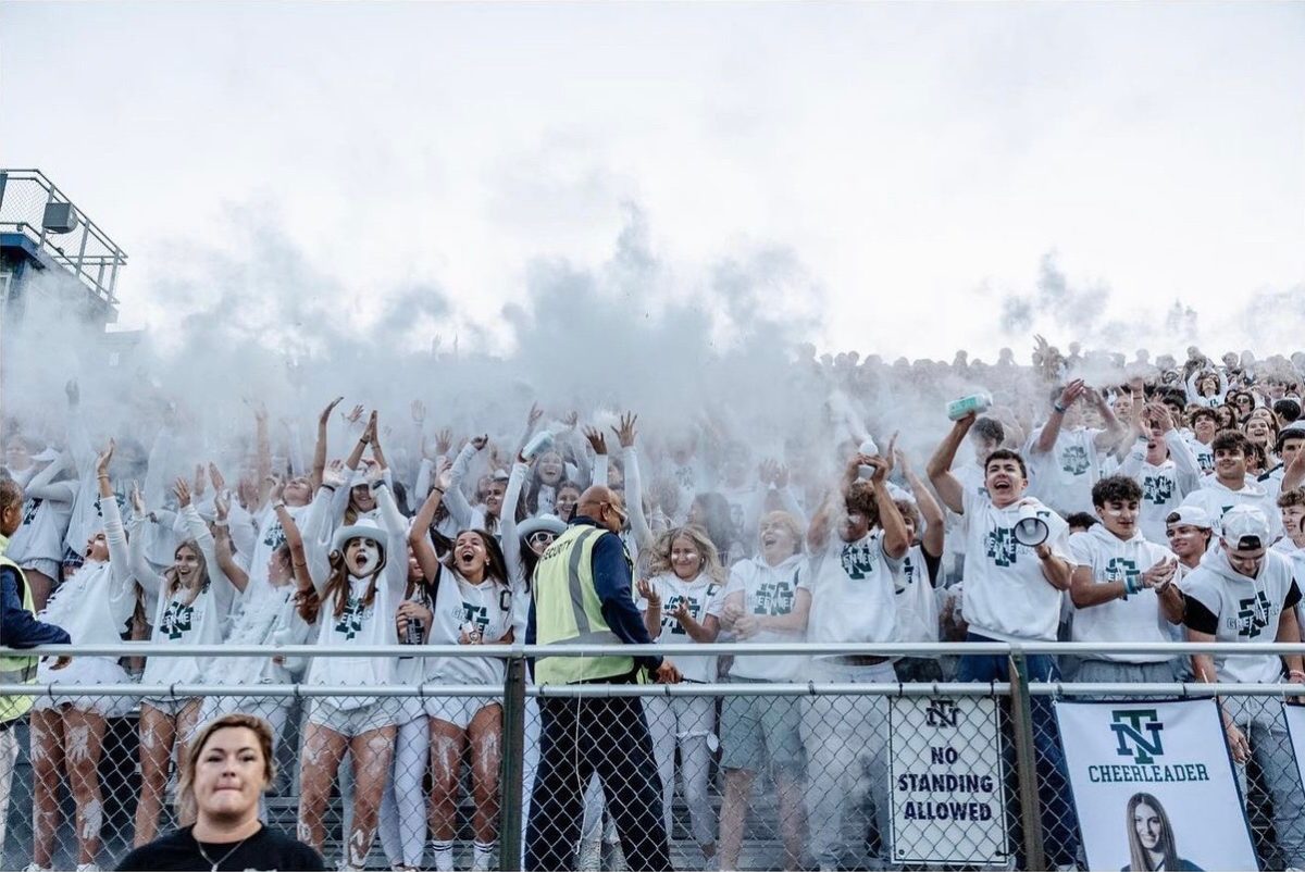 One of the many seniors’ Green Team traditions is throwing baby powder at a New Trier White out football game