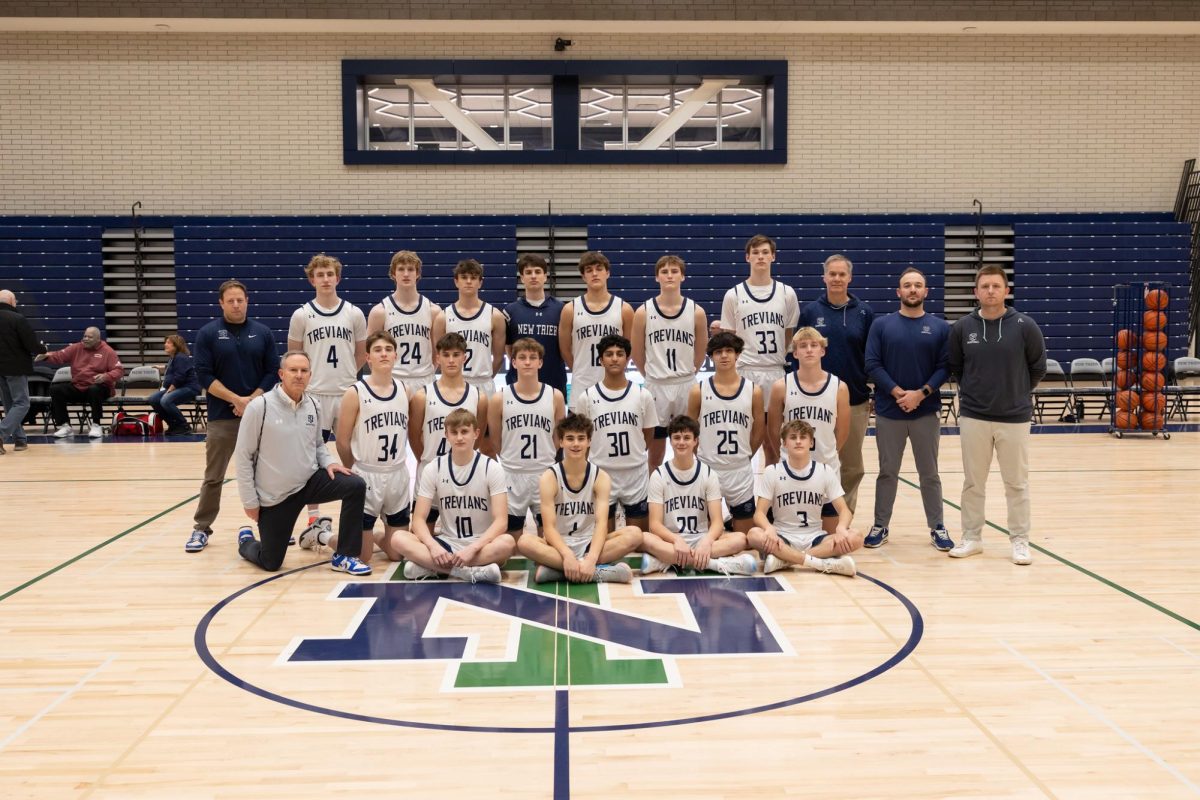Varsity+boys+basketball+players+and+coaches+after+a+58-30+victory+vs.+North+Chicago+on+Jan.+29