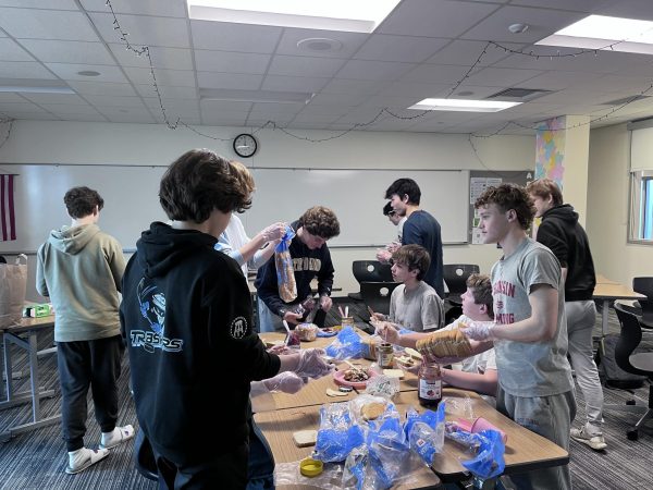 SUN club members make sun butter sandwiches for Connections for the Homeless at a Tuesday meeting