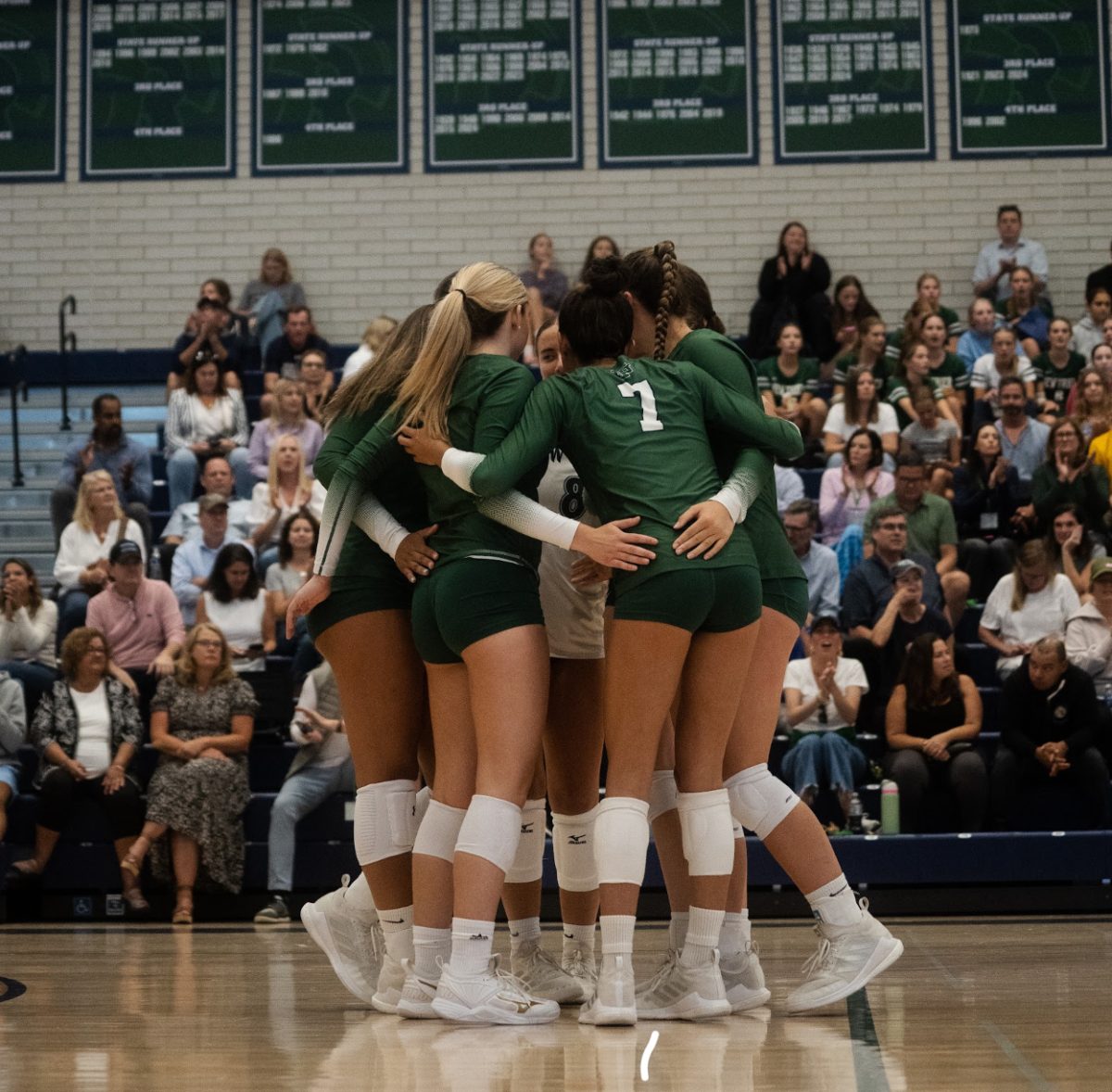 The team huddles together during Sept. 3 victory against Warren Township High School