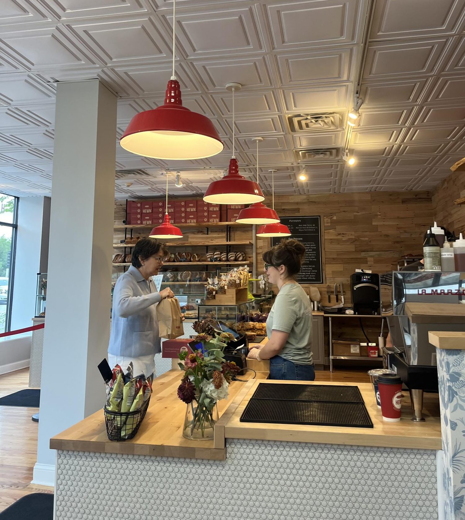 Customer purchases pastries at new Hewn location in Winnetka