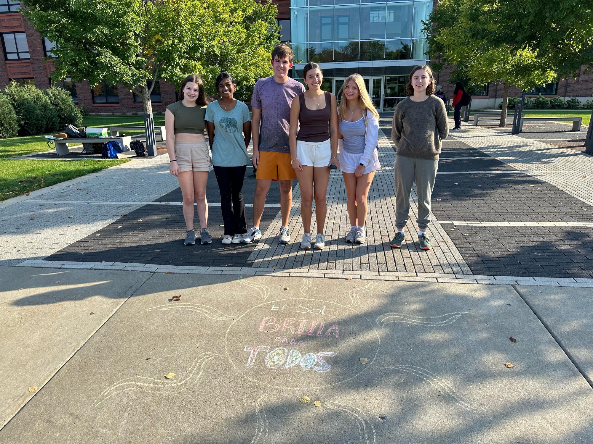 Spanish club members draw on the sidewalk to celebrate Hispanic Heritage Month