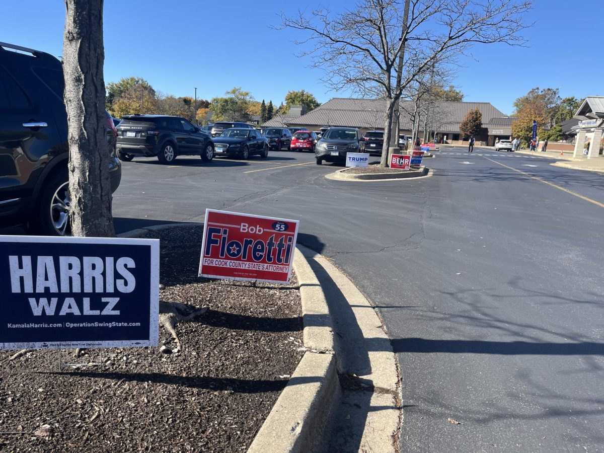 Campaign signs displayed outside of a polling place in Wilmette as people arrive to vote early