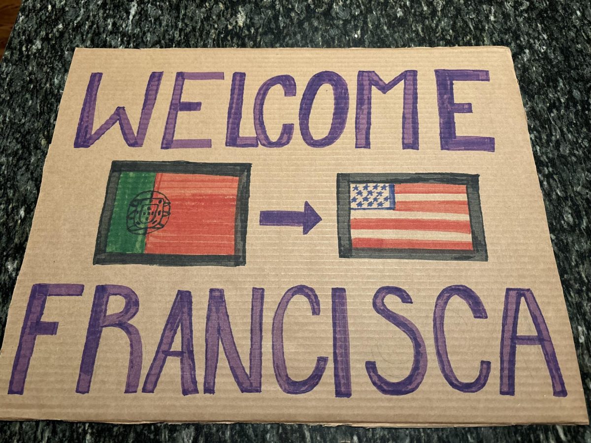 On the day students arrive, families bring fun welcome signs that usually have their student’s name and flag
