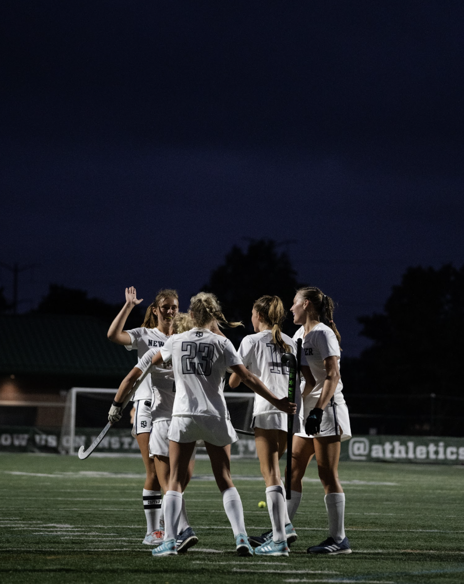 The team embraces after a game-sealing overtime goal from junior Lilly Cimirolli during their home opener against Lake Forest High School