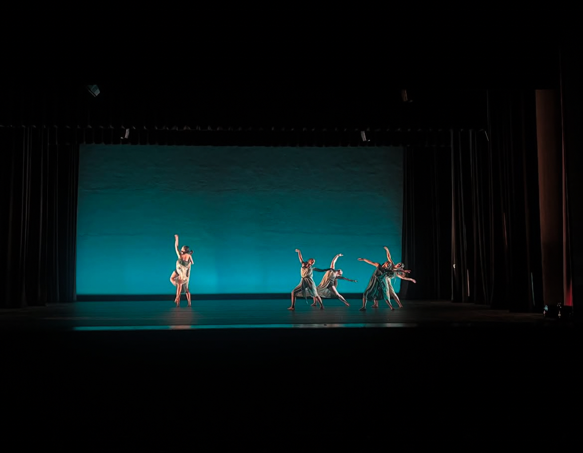 Senior Cate Martin and her dancers practicing 'Windswept' on stage during during tech week