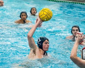 Senior captain Hank Woodman scores a close goal in the team’s senior night win over Maine South High School
