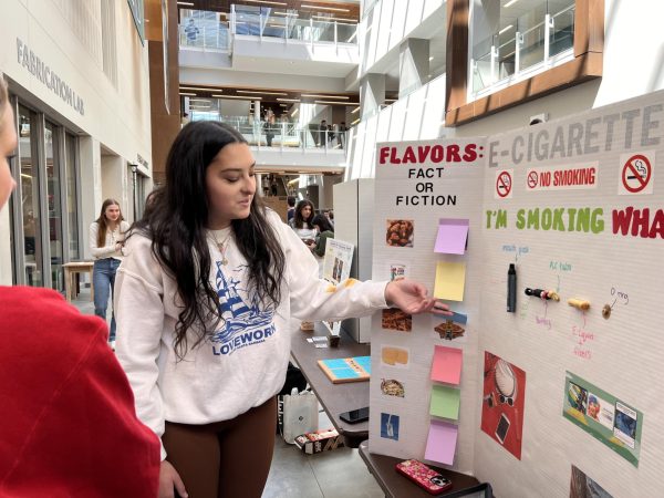 IGSS students present their projects on poster boards at the end of year IGSStravaganza