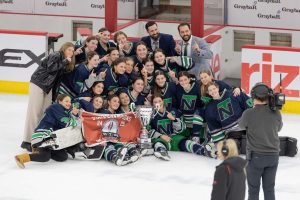 Girls hockey proudly presents their state championship cup and banner after winning 5-4 in a sudden death overtime against Barrington