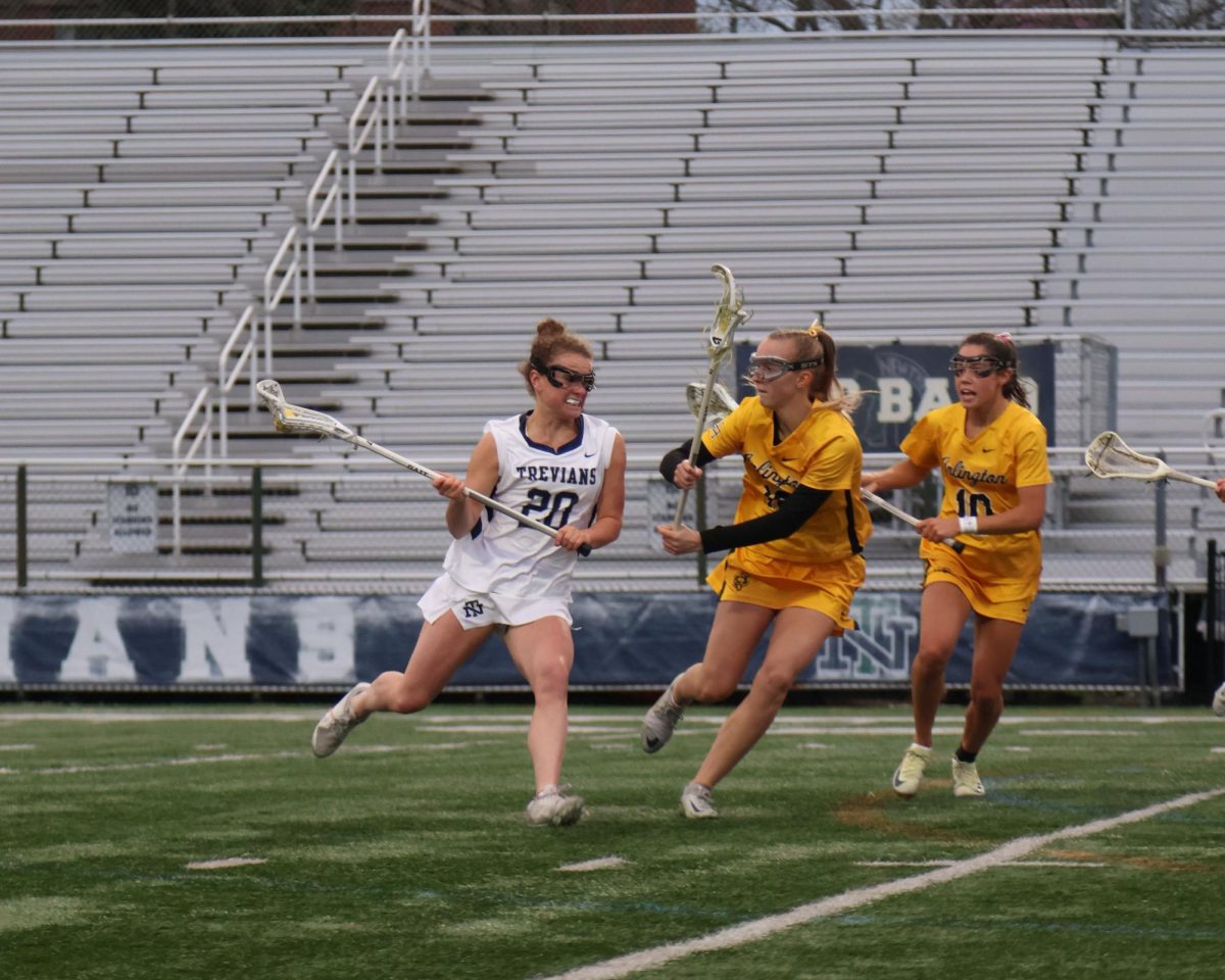 Avery Anderson drives towards the goal as Upper Arlington players defend her