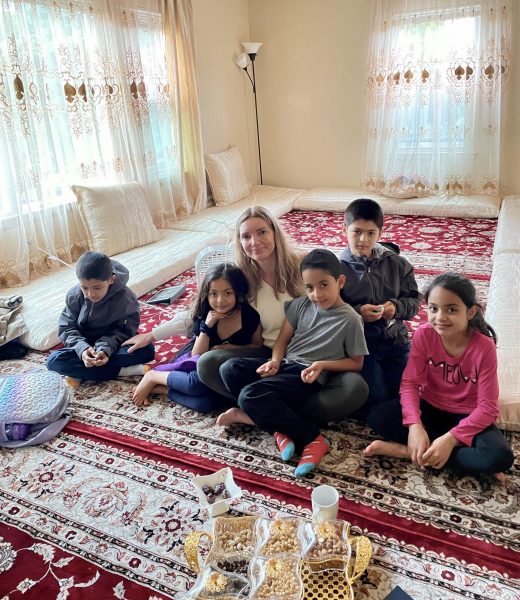 Dita De Leeuw sits with Afghan refugee Roya and her siblings, whom the new nonprofit is named after
