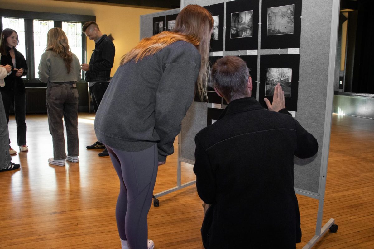 Sears student admires the final product of the art show on May 8