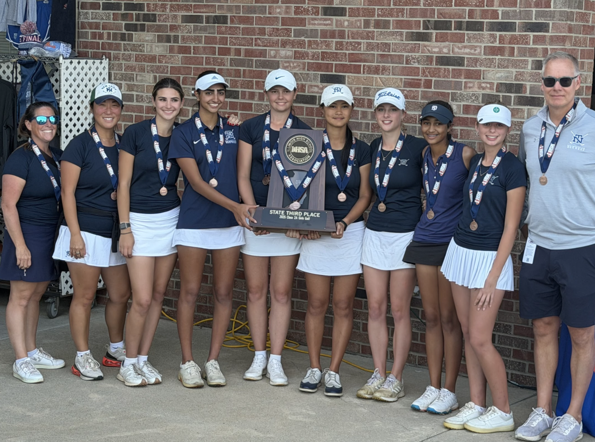 The decorated golf team holds their trophy with head coach Scott Fricke