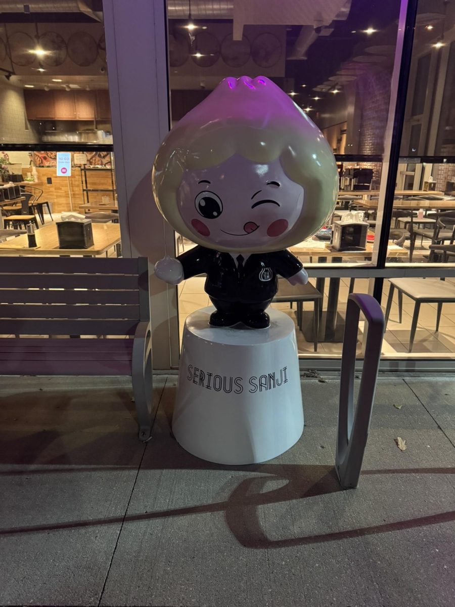 Serious Sanji's mascot standing next to the front door 