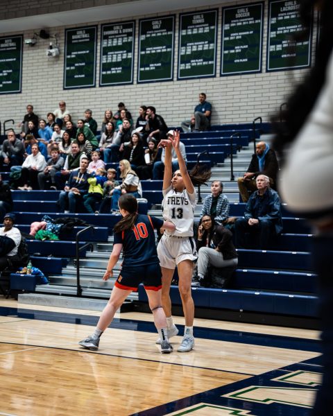 Schecter shoots a corner three in last year's game against Evanston Township High School on Jan. 30